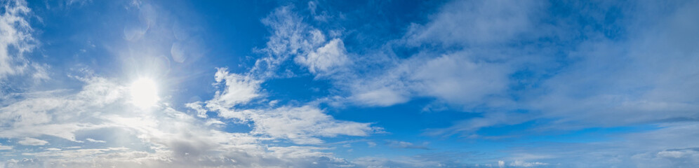 Wall Mural - blue sky with clouds in sunshine (wide natural cloudscape background panorama)