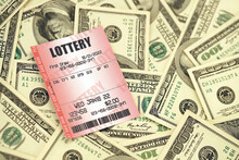 Red Lottery Ticket Lies On Big Amount Of Hundred Dollar Bills. Lottery Playing Concept Or Gambling Addiction. Close Up