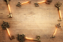 Top View Image Of Old Keys Over Wooden Background