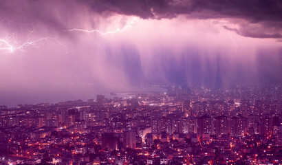 Fototapete - Lightning thunderstorm flash over the city at night sky - Lightning storm over city with rain