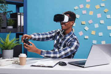 Research department team leader enjoying playing on console using gamepad. Playful office person wearing virtual reality technology headset while using modern controller to play games at work