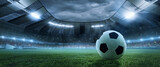 Fototapeta Sport - Collage with soccer football ball lying on grass of football field at crowded stadium with spotlight in evening. Concept of sport, art, energy, power