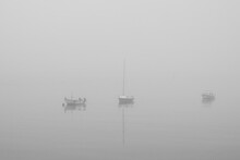Small Boats In A Foggy Morning