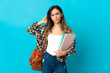 Wall Mural - Young student woman isolated on blue background having doubts