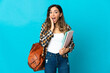 © luismolinero - Young student woman isolated on blue background with surprise and shocked facial expression