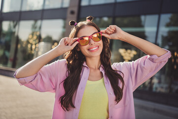 Wall Mural - Portrait of attractive cheerful wavy-haired girl touching specs tour tourism spending free time on fresh air outdoors