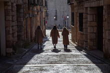 Three Women In Fur Coats Stroll Through A City Before Going Out To Lunch