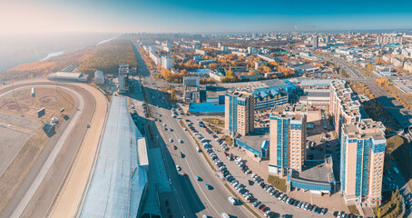 Wall Mural - Aerial view of a city streets and race track stadium and residential block with multi-storey buidlings