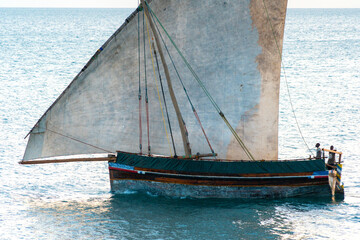 large african sailing dhow on the ocean with a distant blue horizon