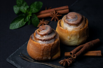 Sticker - Cinnamon rolls on a black background. Fresh homemade cakes. sweet treat