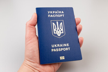 Ukrainian passport with a golden trident symbol on light background. Biometric Ukraine passport id empty place for photo or text.