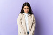© luismolinero - Young caucasian woman isolated on purple background with sad expression