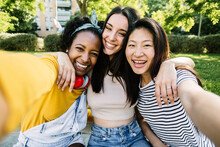 Three Multiracial Best Women Friends Taking Selfie Portrait Together Outdoors - Female Friendship Concept With Happy Diverse Teenager Girls Having Fun In City Street