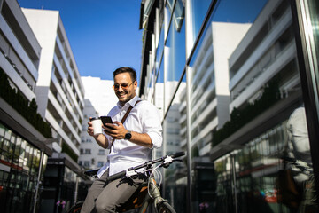 Wall Mural - Business man using phone and drinking coffe