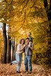 © volody10 - Portrait of happy young family on the background of autumn park. Mom, dad and son are smiling. Family autumn photo shoot