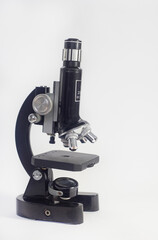 Wall Mural - old analog microscope, mirror on white background with copy space