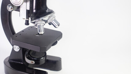 Wall Mural - old analog microscope, mirror on white background with copy space
