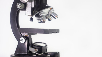 Wall Mural - old analog microscope, mirror on white background with copy space