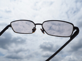 glasses on blue sky background