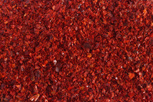 Heap Of Dried Red Chili Flakes As Background. Spices And Herbs. Top View. Free Space For Text.