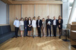 © Studio Romantic - Group portrait of happy multiracial business people. Diverse team of smiling young and mature entrepreneurs or corporate employees standing together in modern office interior