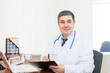 © flipper1971 - Handsome male doctor at the workplace in the clinic