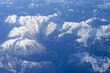 © Oleksandra - Beautiful window view of blue sky, fluffy clouds and Alps mountains from passenger seat on airplane. Travel and air transportation. Holidays