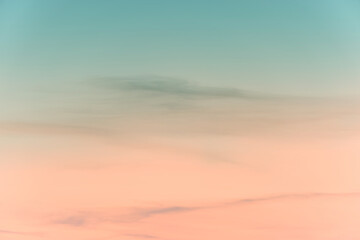 Wall Mural - sunset background. sky with soft and blur pastel colored clouds. gradient cloud on the beach resort.