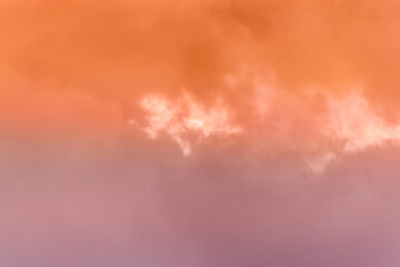 Wall Mural - twilight sky with effect of light pastel orange colors. colorful sunset of soft clouds.