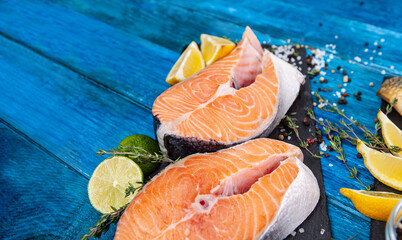 Steaks of red fish on a blue background. Trout steaks with spices.