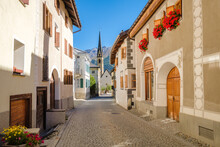 The Village Of S-Chanf In The Upper Engadine Valley (Grisons, Switzerland), Has A Gorgeous Historic Center With Stone Houses And Flower Decorations. The River Inn Flows Through The Village.