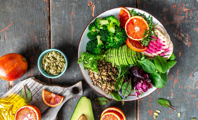 Canvas Print - Healthy vegetarian dish with vegetables, avocado, blood orange, broccoli, watermelon radish, spinach, quinoa, pumpkin seeds. Buddha bowl. Balanced food. Delicious detox diet. Top view