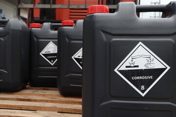 Sticker - Corrosive chemical symbols on a black chemical tank