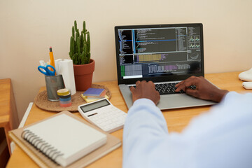 female college student coding on laptop when working on project for computer science class