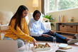 © DragonImages - Joyful teenage girls eating tasty pizza while preparing for exams at home