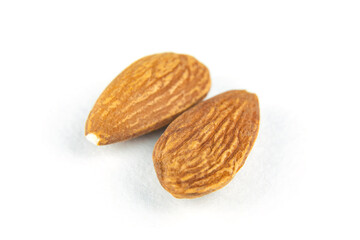 Two nuts close-up. Peeled almonds on a white isolated background.