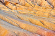 Detail of sandy ripples of color in Death Valley desert mountains