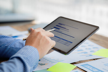 Poster - A business finance woman is reviewing a company's financial documents prepared by the Finance Department for a meeting with business partners. Concept of validating the accuracy of financial numbers.