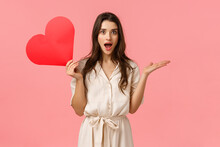 Surprise, Relationship And Love Concept. Amused And Wondered Alluring Woman Didnt Expact Receive Valentines Day Confession, Open Mouth Gasping Excited, Holding Red Heart, Pink Background