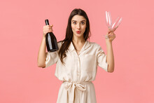 Shall We. Cheerful And Excited Girl Want Celebrate Great News, Open Bottle Champagne And Folding Lips Showing Tempting Suggestion, Holding Two Glasses, Want Drink Together, Pink Background