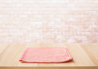 Wall Mural - Red fabric,cloth on wood table top on wall background.