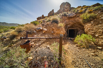 Abandoned mine in desert of Death Valley with shaft entrance