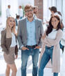 © ASDF - three young employees standing in a modern office