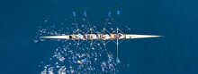Aerial Drone Top Ultra Wide Panoramic View Of Sport Canoe Rowing Synchronous Team Of Athletes Competing In Deep Blue Sea