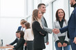 © ASDF - business colleagues greeting each other with a handshake