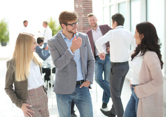 group of employees talking standing in the office.