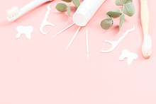 Bamboo Toothbrushes, Electric, Tube Of Toothpaste, Dental Floss, Toothpicks And Chewing Gums On A Soft Pink