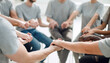 © ASDF - close up. a group of people holding each other's hands