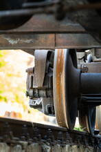 Closeup View Of Old Rusty Wheels Of Train. Railroad Car Chassis On Rail. Freight Transport Concept. 