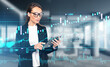 © ImageFlow - Businesswoman with tablet in hands, forex chart and office room